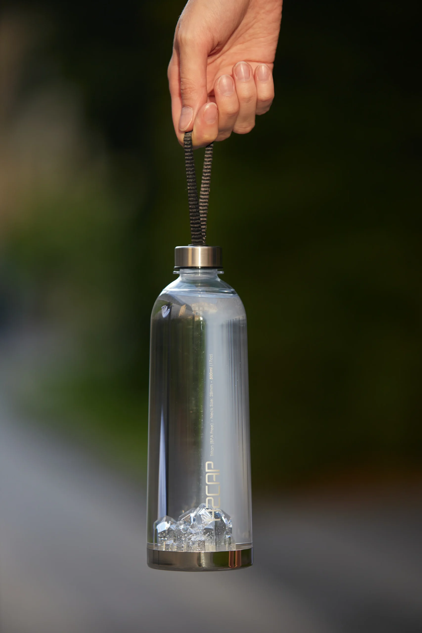 H2CAP PLUS hydrogen water bottle held by its carry strap