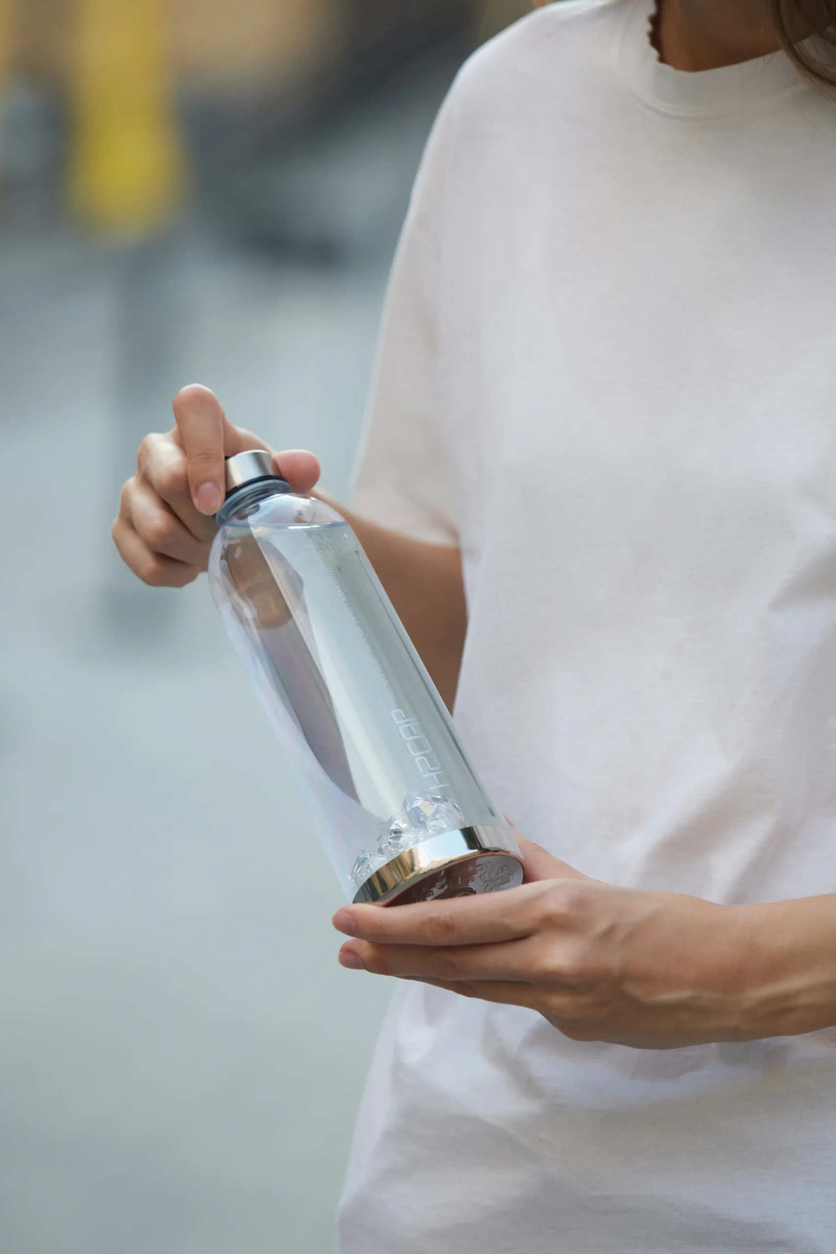 Drinking hydrogen water every day - H2CAP PLUS bottle in hand