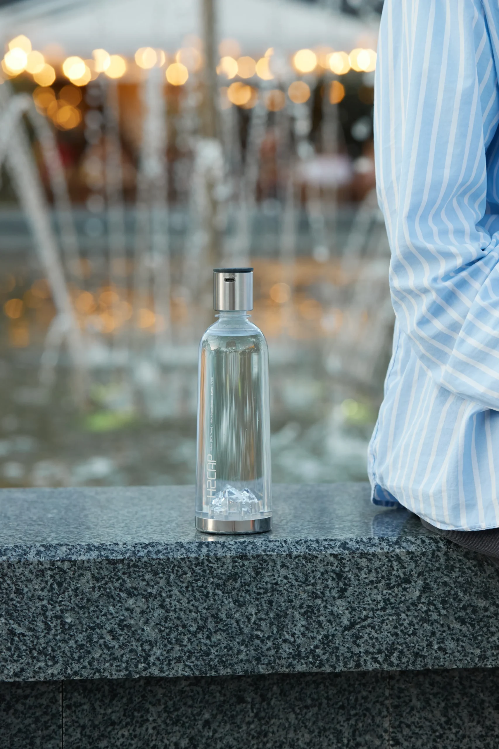 H2CAP PLUS hydrogen water bottle standing on a granite ledge