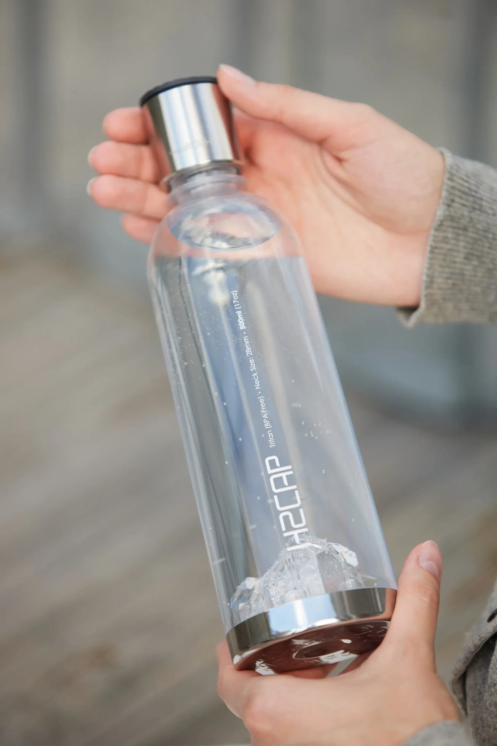 H2CAP PLUS hydrogen water bottle held in hand, showing its size